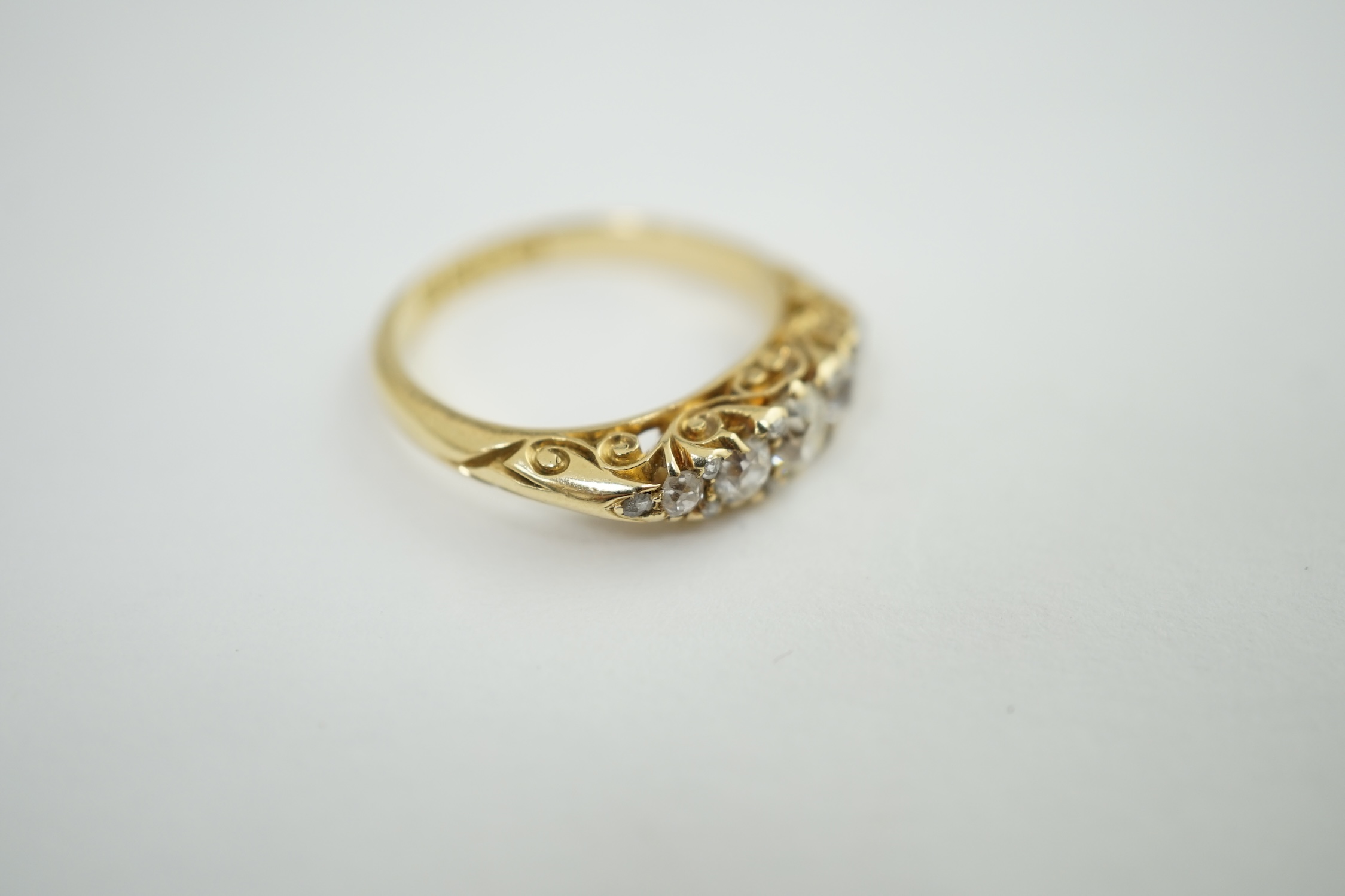 A late Victorian 18ct gold and graduated seven stone diamond set half hoop ring